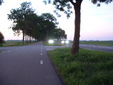 parallel road, daytime, with car with lights on