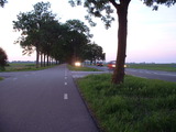 parallel road, daytime, with car with lights on