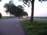 parallel road, daytime, with car with lights on